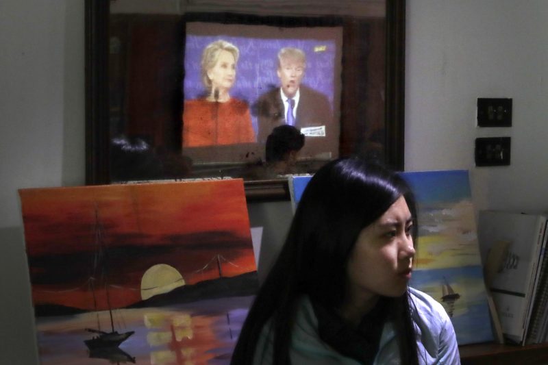 A Chinese woman watches a live broadcasting of the U.S. presidential debate