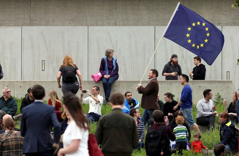 A man waves a European Union flag outside the Scottish Parliament at Holyrood in Edinburgh, Scotland, Britain June 28, 2016.  REUTERS/Scott Heppell 