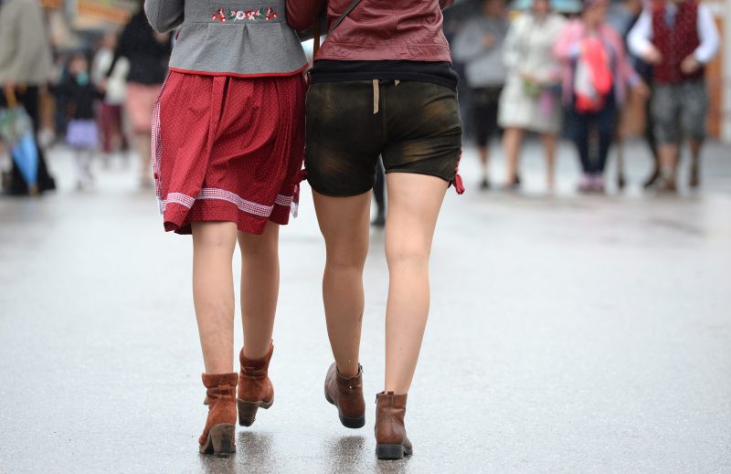 2016-09-18 00:00:00 epa05545505 Two women, one wearing a traditional dirndl dress (L) and one wearing traditional leather pants, walk on the grounds of the Oktoberfest beer festival in Munich, Germany, 18 September 2016. The 183rd edition of the annual folk and beer festival runs from 17 September to 03 October and is expected to attract once more several millions of visitors from all over the world. EPA/ANDREAS GEBERT