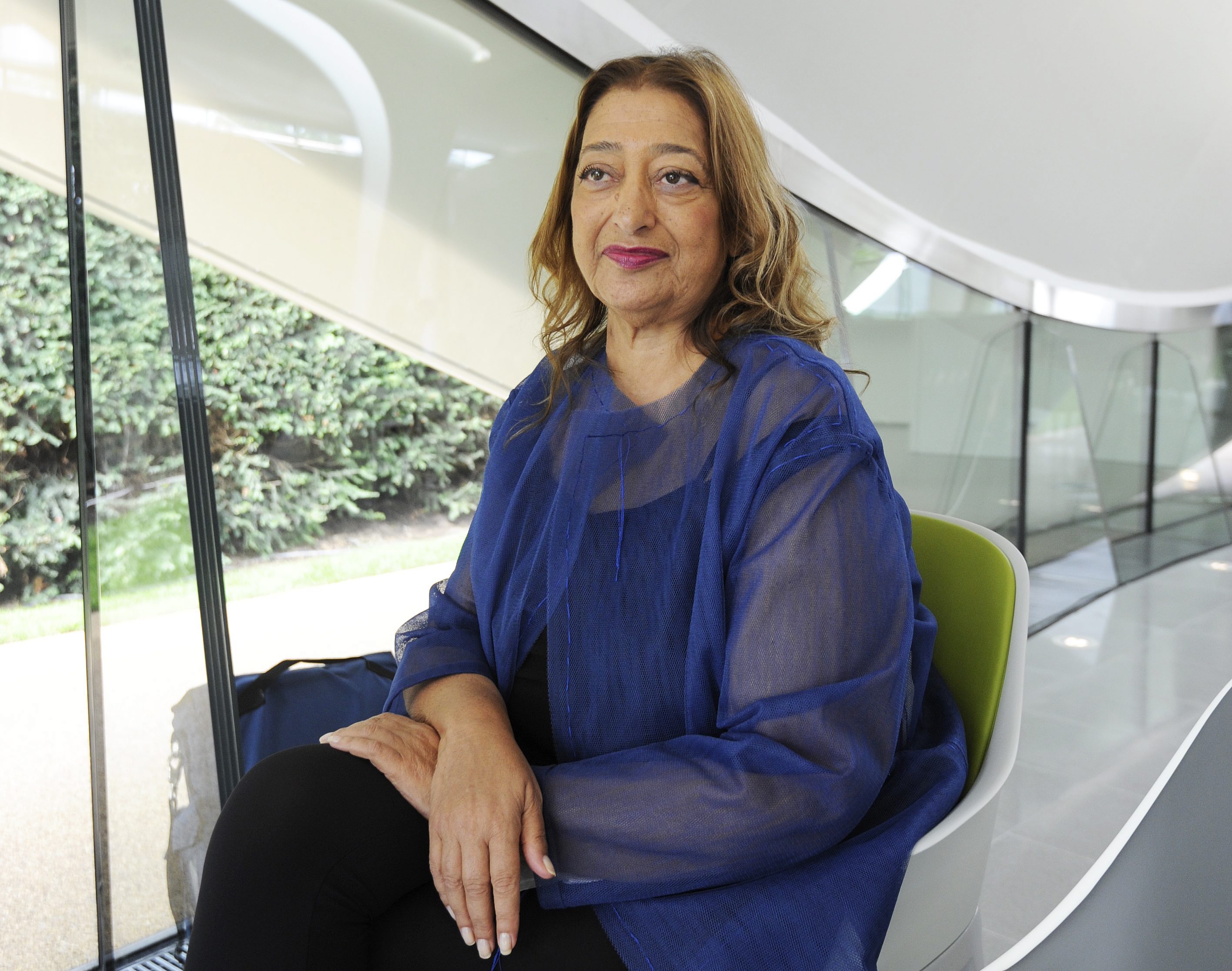 2013-09-25 13:14:09 epa03883207 Iraqi-British architect Zaha Hadid sits inside the newly constructed Serpentine Sackler Gallery during a television interview, in Kensington Gardens in London, Britain, 25 September2013. The renovation of the former 1805 gunpowder store was designed by Zaha Hadid Architects. EPA/FACUNDO ARRIZABALAGA