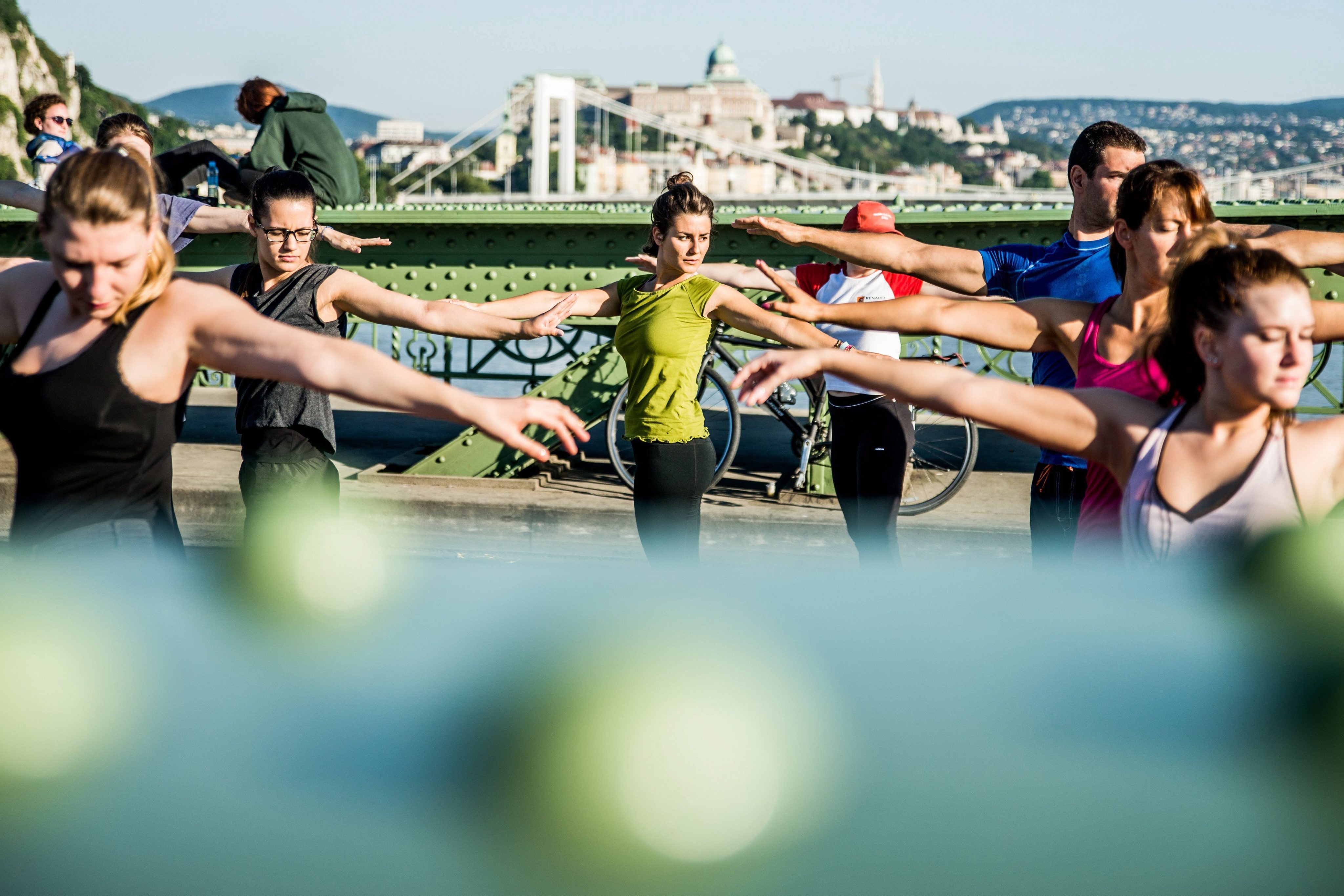2016-07-21 07:07:16 epa05434529 People perform yoga exercises on Liberty Bridge, which is closed from traffic due to tram network development of South Buda in Budapest, Hungary, 21 July 2016. EPA/ZOLTAN BALOGH HUNGARY OUT