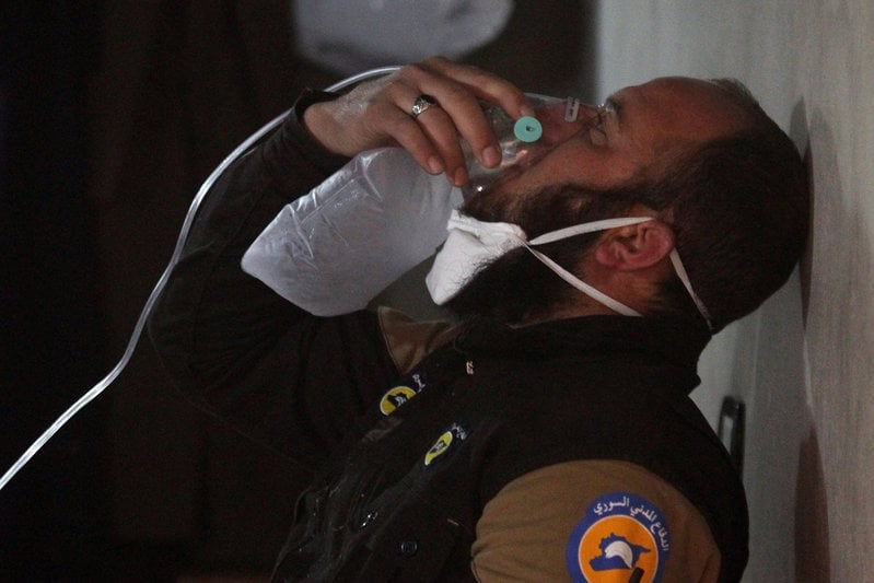 A civil defence member breathes through an oxygen mask, after what rescue workers described as a suspected gas attack in the town of Khan Sheikhoun in rebel-held Idlib, Syria April 4, 2017. REUTERS/Ammar Abdullah     