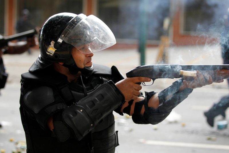 Venezuela police national guard riot shotgun weapon tear gas protest