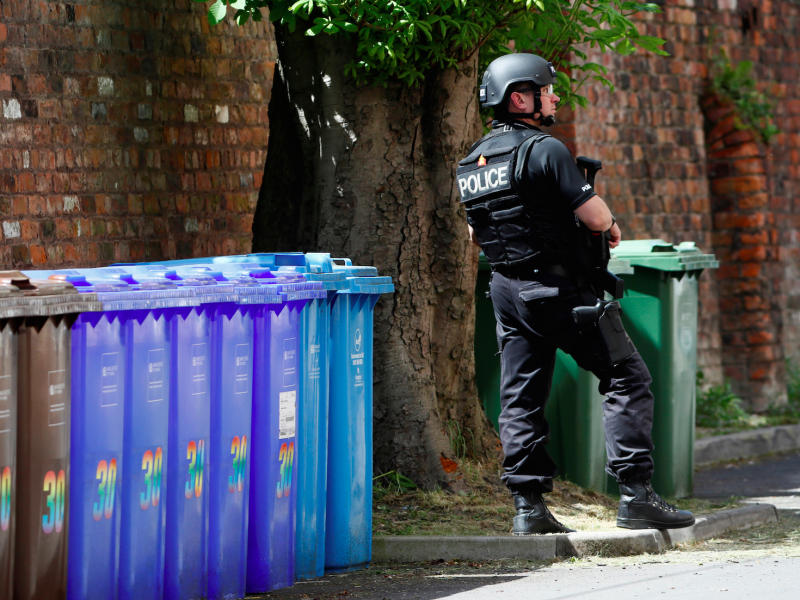 An armed police officer stands outside a residential property near to where a man was arrested in the Chorlton area of Manchester, Britain May 23, 2017.