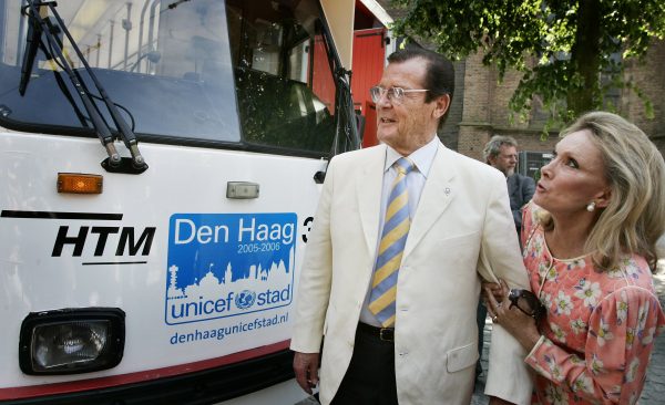 Roger Moore en zijn echtgenote Kristina bekijken in 2005 de Unicef tram in Den Haag waar Unicef het vijftigjarige bestaan van de Nederlandse afdeling viert.