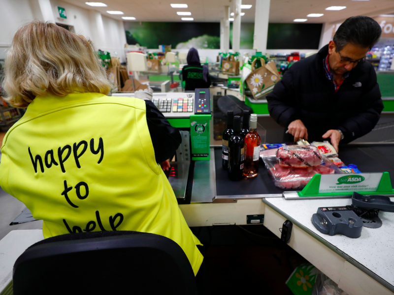 An employee works on a checkout till at the Asda superstore in High Wycombe, Britain, February 8, 2017.