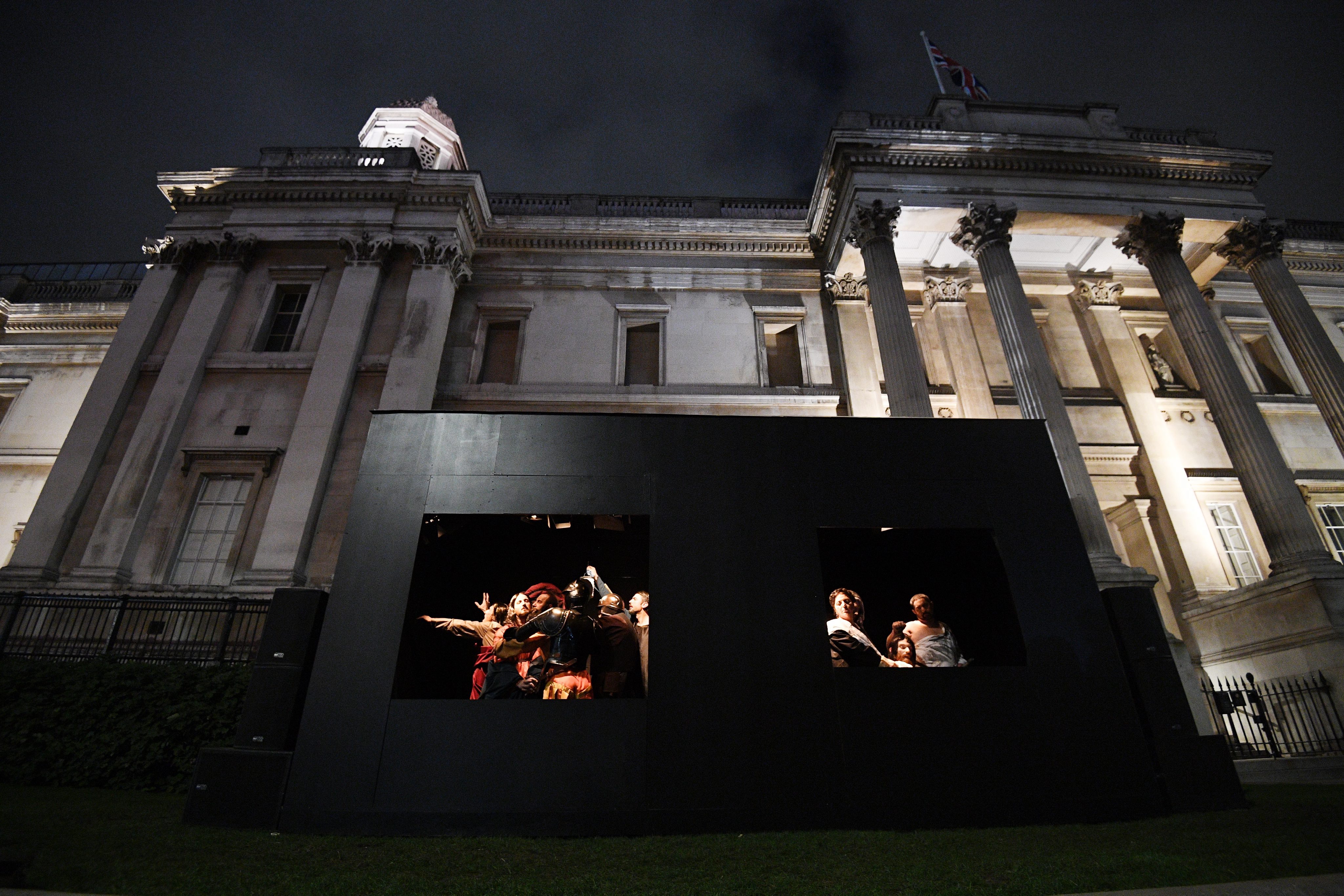2016-10-28 17:40:13 epa05607471 Two Caravaggio masterpieces are being recreated as living paintings in front of the National Gallerys building on Trafalgar Square in London, Britain, 28 October 2016. To celebrate the Beyond Caravaggio exhibition the gallery has commissioned renowned Italian performance troupe Quadri Plastici to recreate The Taking of Christ using models, lights, props, and box frames together with music. EPA/FACUNDO ARRIZABALAGA