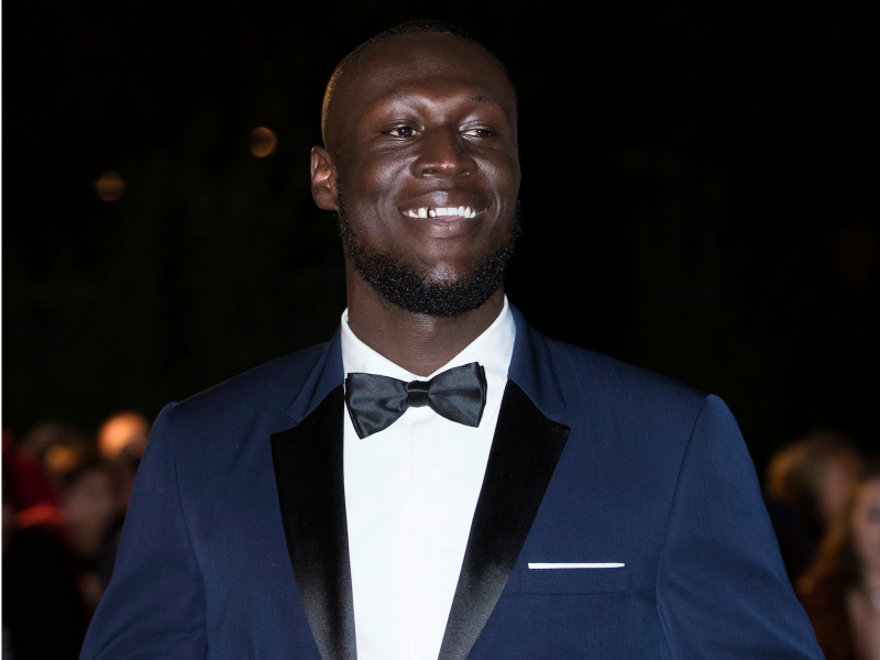 Stormzy poses for photographers upon arrival at the GQ's Men of The Year awards, in London, Tuesday, Sept. 5, 2017.