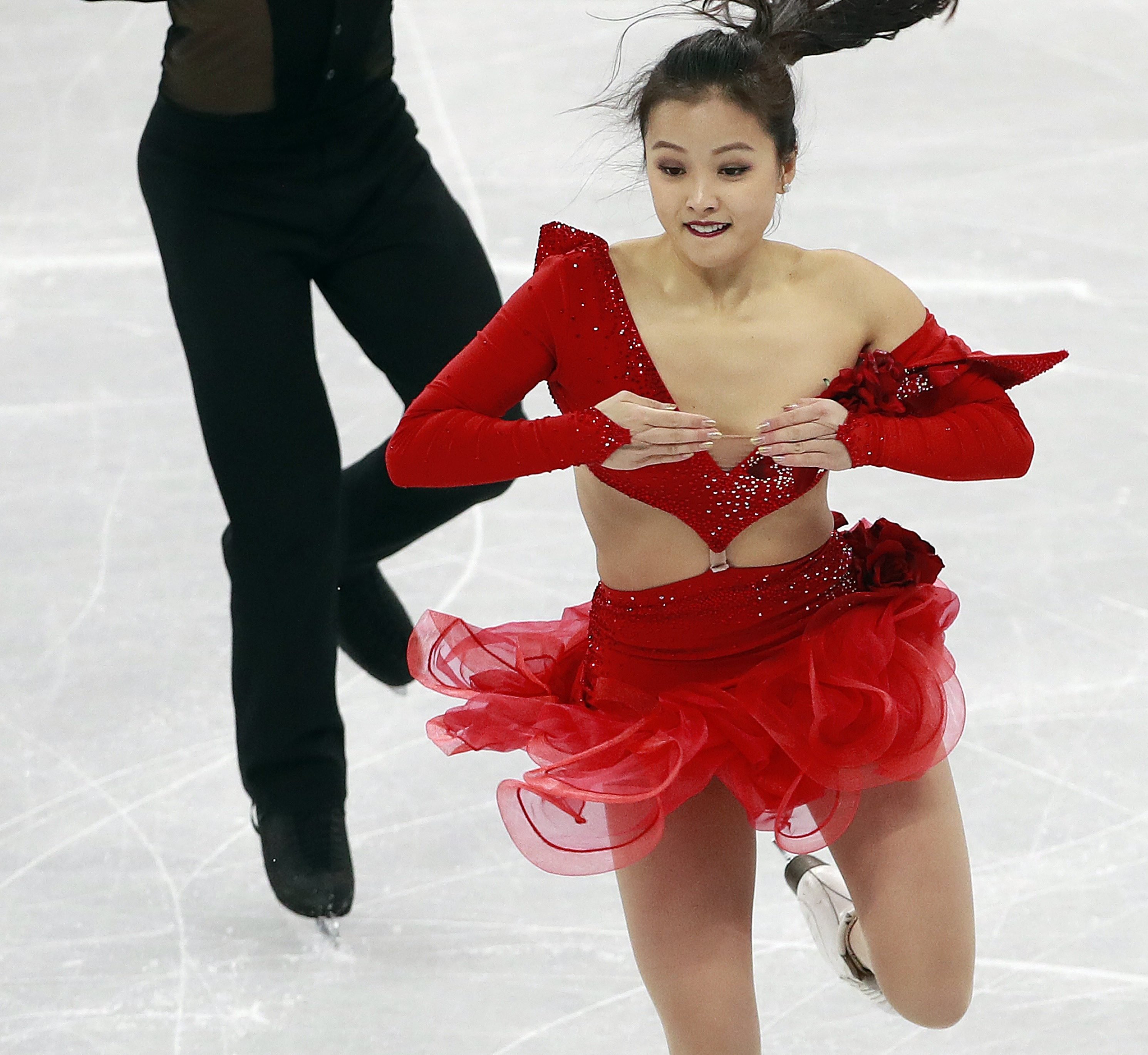 2018-02-11 10:09:10 epa06514007 Yura Min has part of her costume slide off her left shoulder after a clasp came undone (R) as she and Alexander Gamelin of South Korea compete during the Ice Dance Short Dance of the Figure Skating Team Event competition at the Gangneung Ice Arena during the PyeongChang 2018 Olympic Games, South Korea, 11 February 2018. EPA/HOW HWEE YOUNG