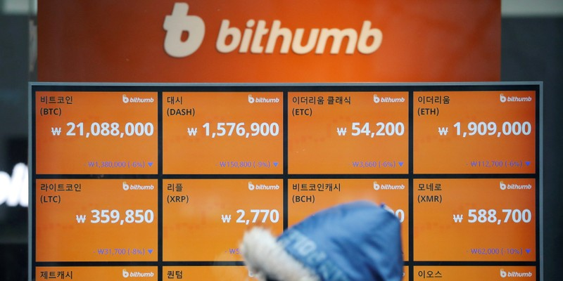 A man walks past an electric board showing exchange rates of various cryptocurrencies at Bithumb cryptocurrencies exchange in Seoul, South Korea, January 11, 2018.  REUTERS/Kim Hong-Ji
