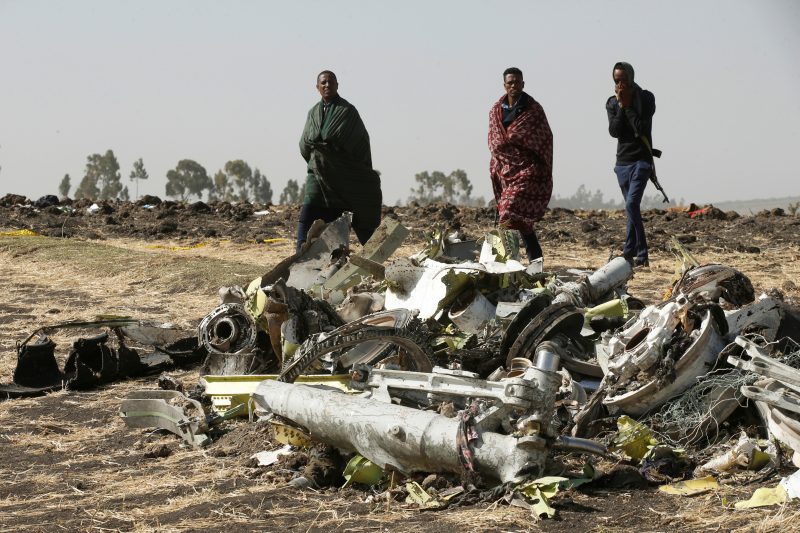 Ethiopian police officers walk past the debris of the Ethiopian Airlines Flight ET 302 plane crash, near the town of Bishoftu, near Addis Ababa, Ethiopia March 12, 2019. REUTERS/Baz Ratner