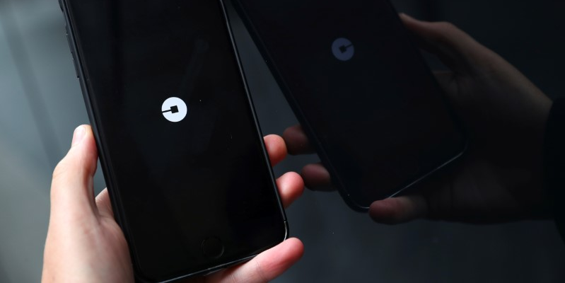 FILE PHOTO: The Uber logo is seen on mobile telephone in London, Britain, September 25, 2017. REUTERS/Hannah McKay/File Photo