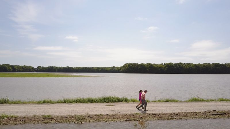 Farmers walk in their flooded farm in the Mississippi Delta region.