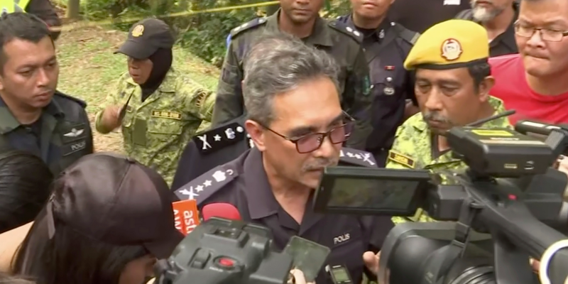 Negeri Sembilan state police chief Mohamad Mat Yusop, center, speaks to media in Pantai, Malaysia Tuesday, Aug. 13, 2019. Malaysian rescuers on Tuesday found the body of a Caucasian female in the forest surrounding a nature resort where a 15-year-old London girl was reported missing more than a we
