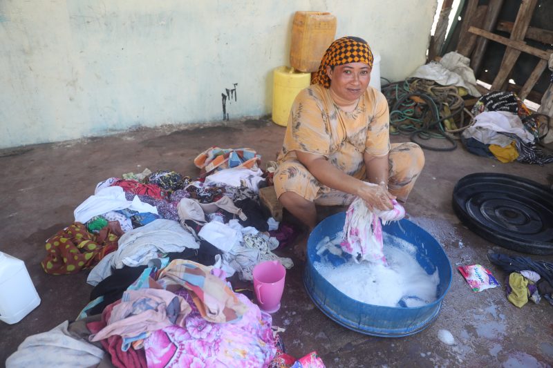 Woman washing clothes saltwater kiunga kenya