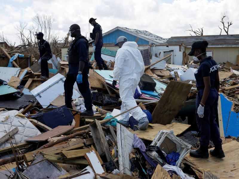 FILE PHOTO: Police officers search for the dead in the destroyed Mudd neighborhood after Hurricane Dorian hit the Abaco Islands in Marsh Harbour, Bahamas, September 10, 2019. REUTERS/Marco Bello