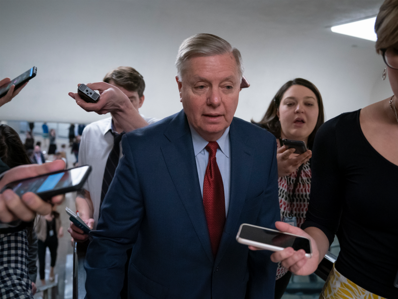 IN this March 13, 2019, photo, reporters pose questions to Sen. Lindsey Graham, R-S.C., at the Capitol in Washington, Wednesday, March 13, 2019. The Republican-led Senate is set to deal President Donald Trump a rebuke on his declaration of a national emergency at the Mexican border, with the only remaining question how many GOP senators will join Democrats in defying him. (AP Photo/J. Scott Applewhite)