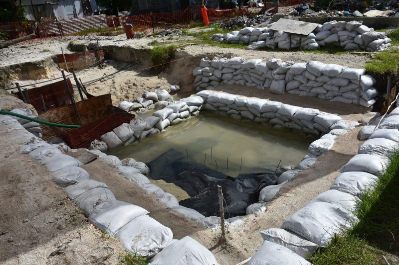 This June 1, 2019 photo provided by History Flight shows graves of U.S. servicemen under the water table in Tarawa, Kiribati. A nonprofit organization that searches for the remains of U.S. servicemen lost in past conflicts has found what officials believe are the graves of more than 30 Marines and sailors killed in one of the bloodiest battles of World War II. (Eric Albertson/Defense POW/MIA Accounting Agency/History Flight via AP)