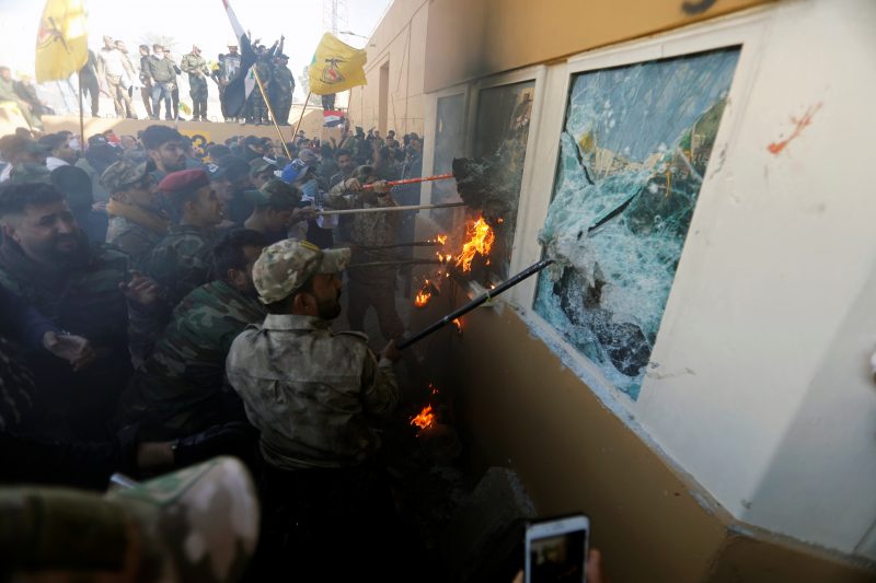 Protesters and militia fighters attack a reception room of the U.S. Embassy, during a protest to condemn air strikes on bases belonging to Hashd al-Shaabi (paramilitary forces), in Baghdad, Iraq December 31, 2019.