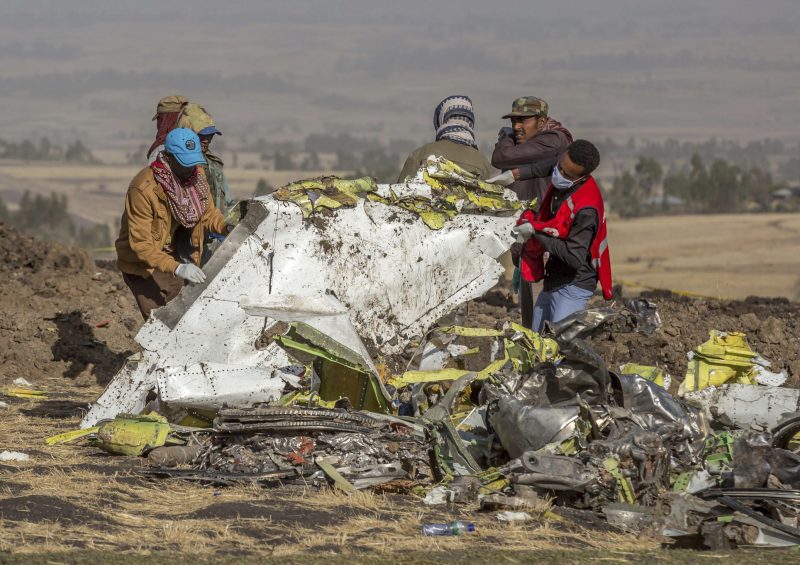 FILE - In this file photo dated Monday, March 11, 2019, rescuers work at the scene of an Ethiopian Airlines plane crash south of Addis Ababa, Ethiopia.  The number of deaths in major air crashes around the globe fell by more than half in 2019 according to a report released Wednesday Jan. 1, 2020, by the aviation consultancy To70, revealing the worst crash for the year was an Ethiopian Airlines Boeing 737 MAX on March 10 that lost 157 lives. (AP Photo/Mulugeta Ayene, FILE)