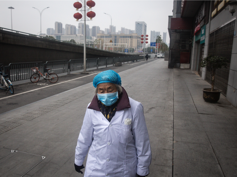 A woman walks on an empty road on January 27, 2020 in Wuhan, China.