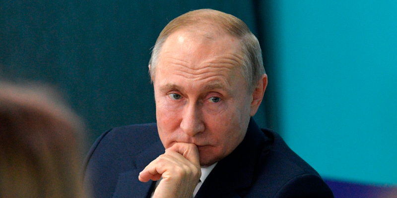 Russian President Vladimir Putin listens for a question as he visits the 