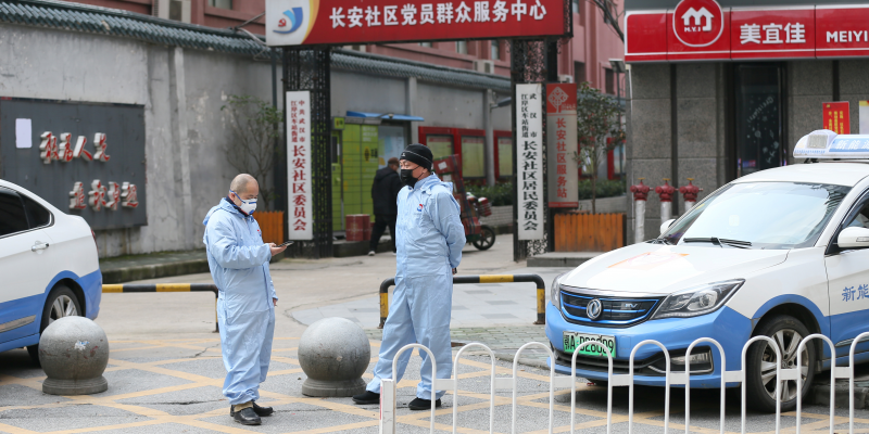 FILE PHOTO: Taxi drivers in protective suits are seen in front of a residential area, following an outbreak of the new coronavirus and the city’s lockdown, in Wuhan, Hubei province, China January 28, 2020. Picture taken China Daily via REUTERS
