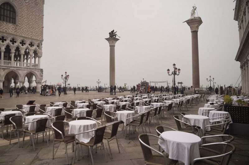 Empty tables sit in St. Mark's square in Venice, Italy, Tuesday, Feb. 25, 2020.