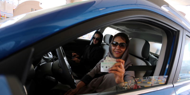 A Saudi woman smiles with her national ID at the Bahrain immigration checkpoint, as she drives to Bahrain on the King Fahd Causeway, a bridge connecting the two countries, at the Bahrain-Saudi border, August 22, 2019. REUTERS/Hamad I Mohammed