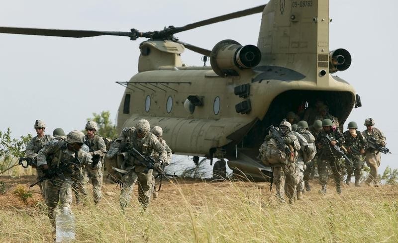 U.S. soldiers of 2nd Stryker Brigade Combat Team disembark from a U.S. military helicopter CH-47 as they take part in the annual 