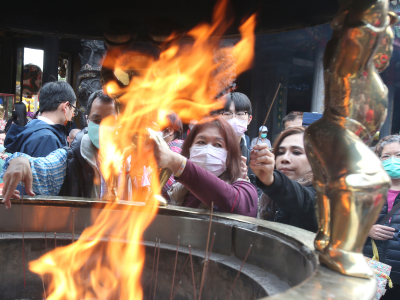 People wear face masks to protect against the spread of the coronavirus as they pray at the popular Longshan Temple in Taipei, Taiwan, Thursday, March 12, 2020. (AP Photo   Chiang Ying ying)