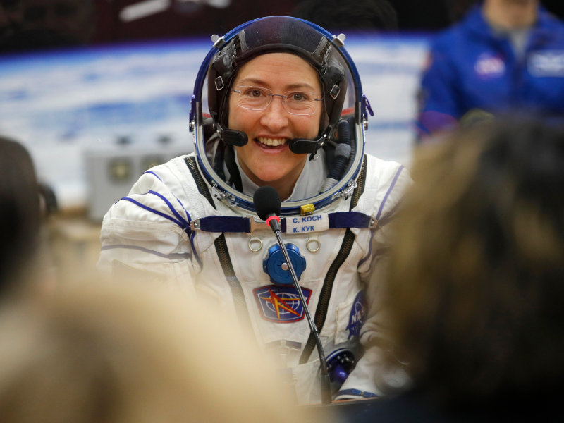 FILE - In this Thursday, March 14, 2019 file photo, U.S. astronaut Christina Koch, member of the main crew of the expedition to the International Space Station (ISS), speaks with her relatives through a safety glass prior the launch of Soyuz MS-12 space ship at the Russian leased Baikonur cosmodrome, Kazakhstan.  Koch told The Associated Press on Tuesday, Jan. 28, 2020, her 319th consecutive day in space _ that taking part in the first all-female spacewalk was the highlight of her mission. She's been living on the International Space Station since March and returns to Earth on Feb. 6, landing in Kazakhstan with two colleagues aboard a Russian capsule.  (AP Photo/Dmitri Lovetsky, Pool)