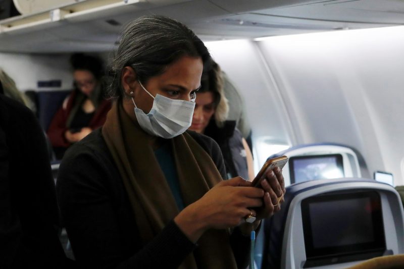Woman in face mask with phone