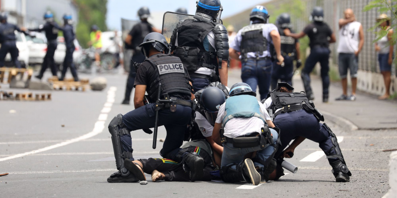 French police officers arrest a demonstrator in Le Port on March 1, 2020, as people protest against the arrival of the passengers of the Sun Princess cruise ship on the Indian Ocean island of La Reunion without having their temperature checked. (Photo by Richard BOUHET / AFP) (Photo by RICHARD BOUHET/AFP via Getty Images)