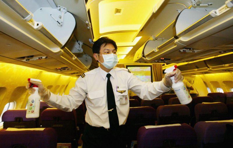 Flight attendant cleans dirty airplane disinfectant