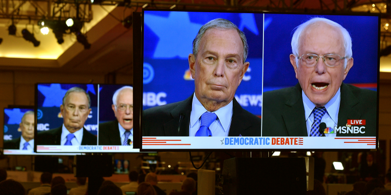 FILE PHOTO: Former New York City Mayor Mike Bloomberg and Senator Bernie Sanders are seen on video screens in the media filing center during the ninth Democratic 2020 U.S. Presidential candidates debate at the Paris Theater in Las Vegas, Nevada, U.S., February 19, 2020. REUTERS/David Becker/File Photo