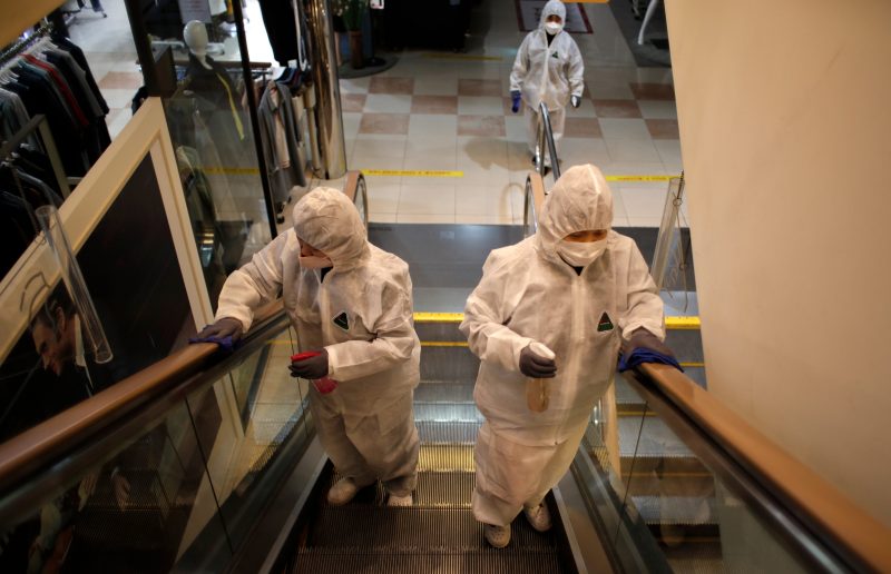 Workers wearing protective gear spray disinfectant as a precaution against the new coronavirus at a department store in Seoul, South Korea, Monday, March 2, 2020. South Korea has the world's second-highest cases. (AP Photo/Lee Jin-man)