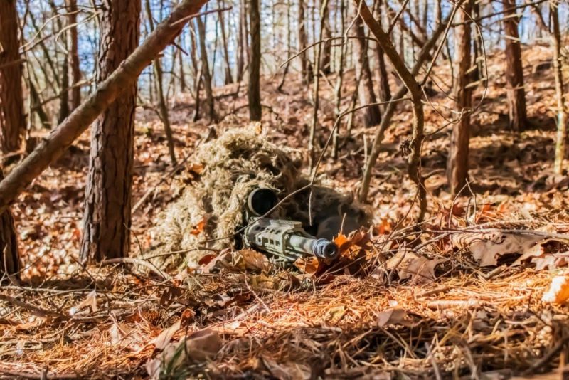Sniper in position in the woods