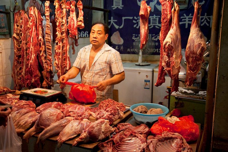 A merchant at an indoor wet market in Beijing, China, in 2012.