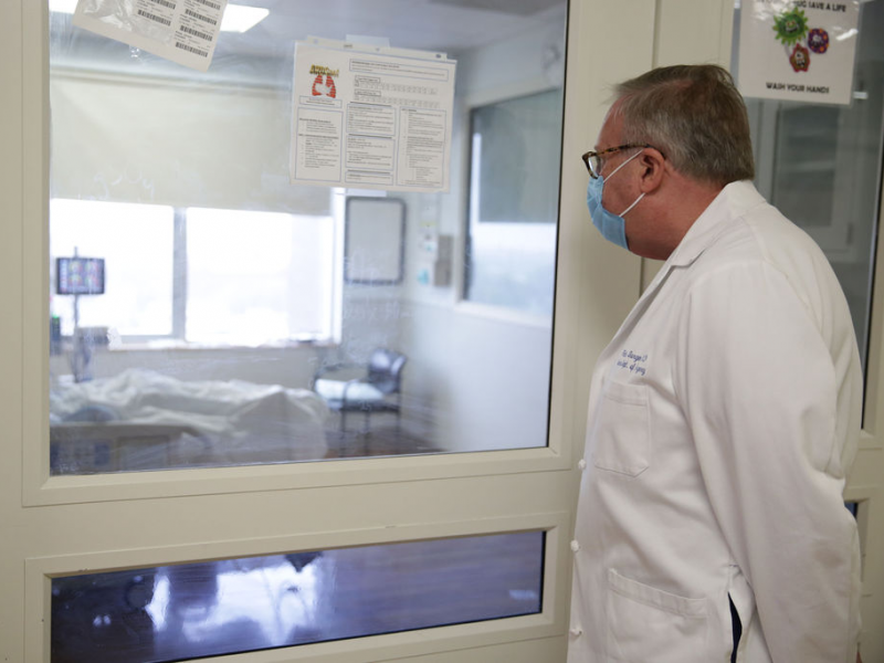 Maimonides chair of surger Dr. Patrick Borgen looks in on a patient in an ICU room.
