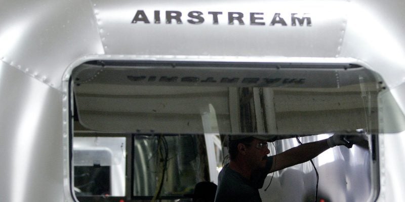 Employees work on an Airstream travel trailer at the Airstream factory Wednesday, Oct. 22, 2014, in Jackson Center, Ohio.