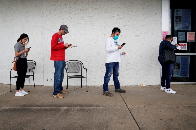 FILE PHOTO: People who lost their jobs wait in line to file for unemployment following an outbreak of the coronavirus disease (COVID-19), at an Arkansas Workforce Center in Fayetteville, Arkansas, U.S. April 6, 2020. REUTERS/Nick Oxford