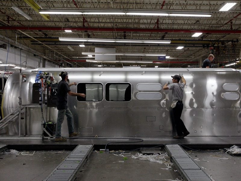 Employees work on an Airstream travel trailer at the Airstream factory Oct. 22, 2014, in Jackson Center, Ohio.