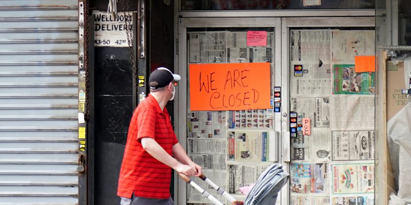 NEW YORK, NEW YORK - MAY 25: A man wearing a protective mask while pushing a stroller looks at a sign in a store window which reads 'WE ARE CLOSED' in Sunnyside during the coronavirus pandemic on May 25, 2020 in the Queens Borough of New York City. Government guidelines encourage wearing a mask in public with strong social distancing in effect as all 50 states in the USA have begun a gradual process to slowly reopen after weeks of stay-at-home measures to slow the spread of COVID-19. (Photo by Cindy Ord/Getty Images)