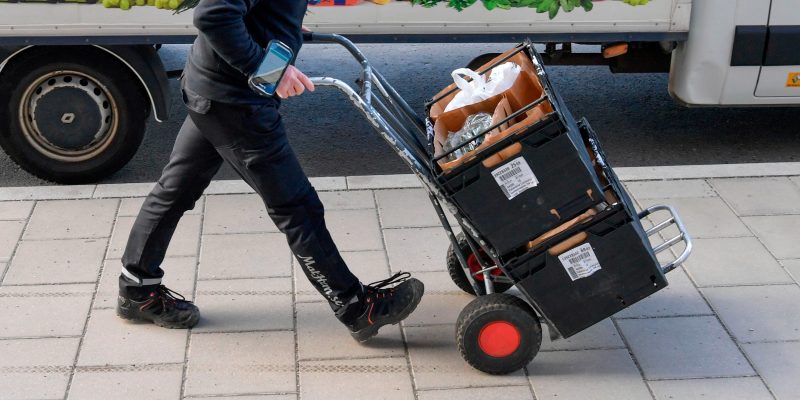 A worker delivers grocery bags to households in Stockholm, Sweden, on March 21, 2020 as internet shopping of food stuffs have skyrocketed in Sweden since the start of the Coronavirus Covid-19 outbreak. (Photo by Anders WIKLUND / various sources / AFP) / Sweden OUT (Photo by ANDERS WIKLUND/TT News Agency/AFP via Getty Images)