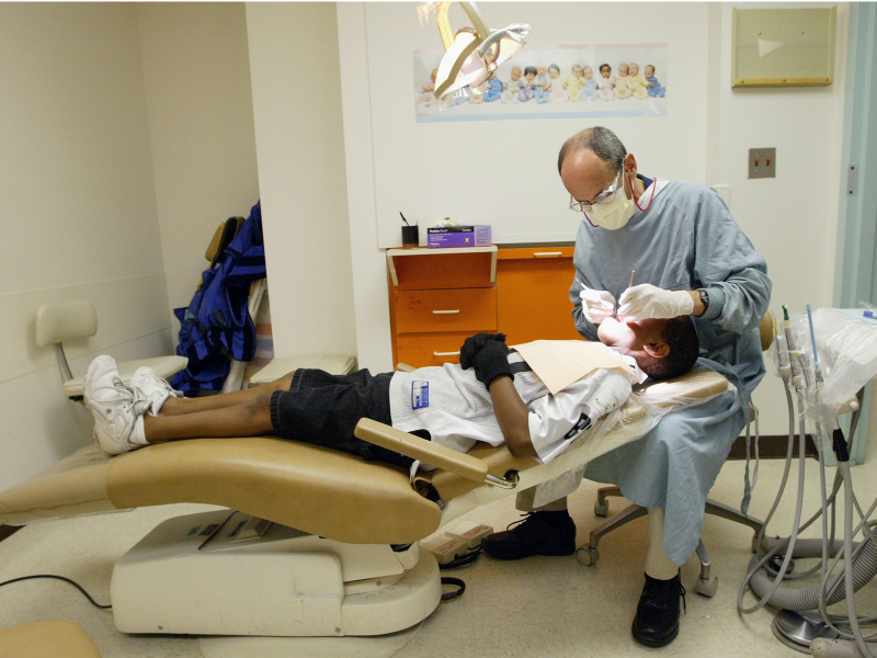 A dentist performs a dental examination.