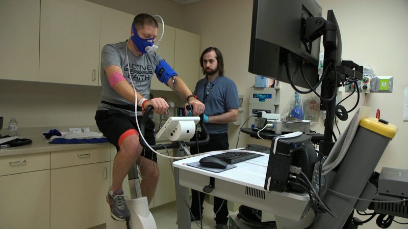 In this Nov. 18, 2019 image from video, Zach Ault of Paducah, Ky., is connected to medical monitors during an exercise test at the National Institutes of Health's hospital in Bethesda, Md. Ault has ME/CFS, what once was called 