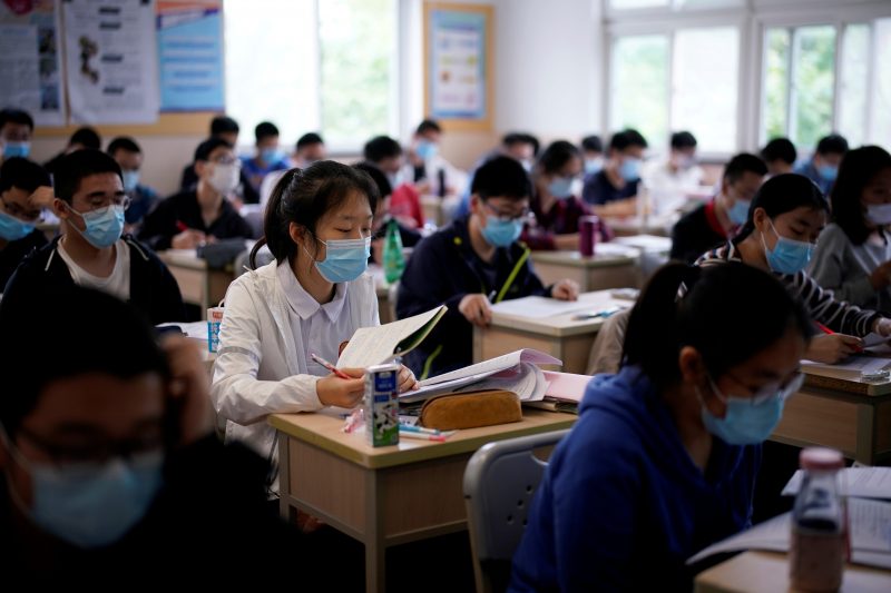 FILE PHOTO: Students wearing face masks are seen inside a classroom during a government-organised media tour at a high school as more students returned to campus following the coronavirus disease (COVID-19) outbreak, in Shanghai, China May 7, 2020.  REUTERS/Aly Song
