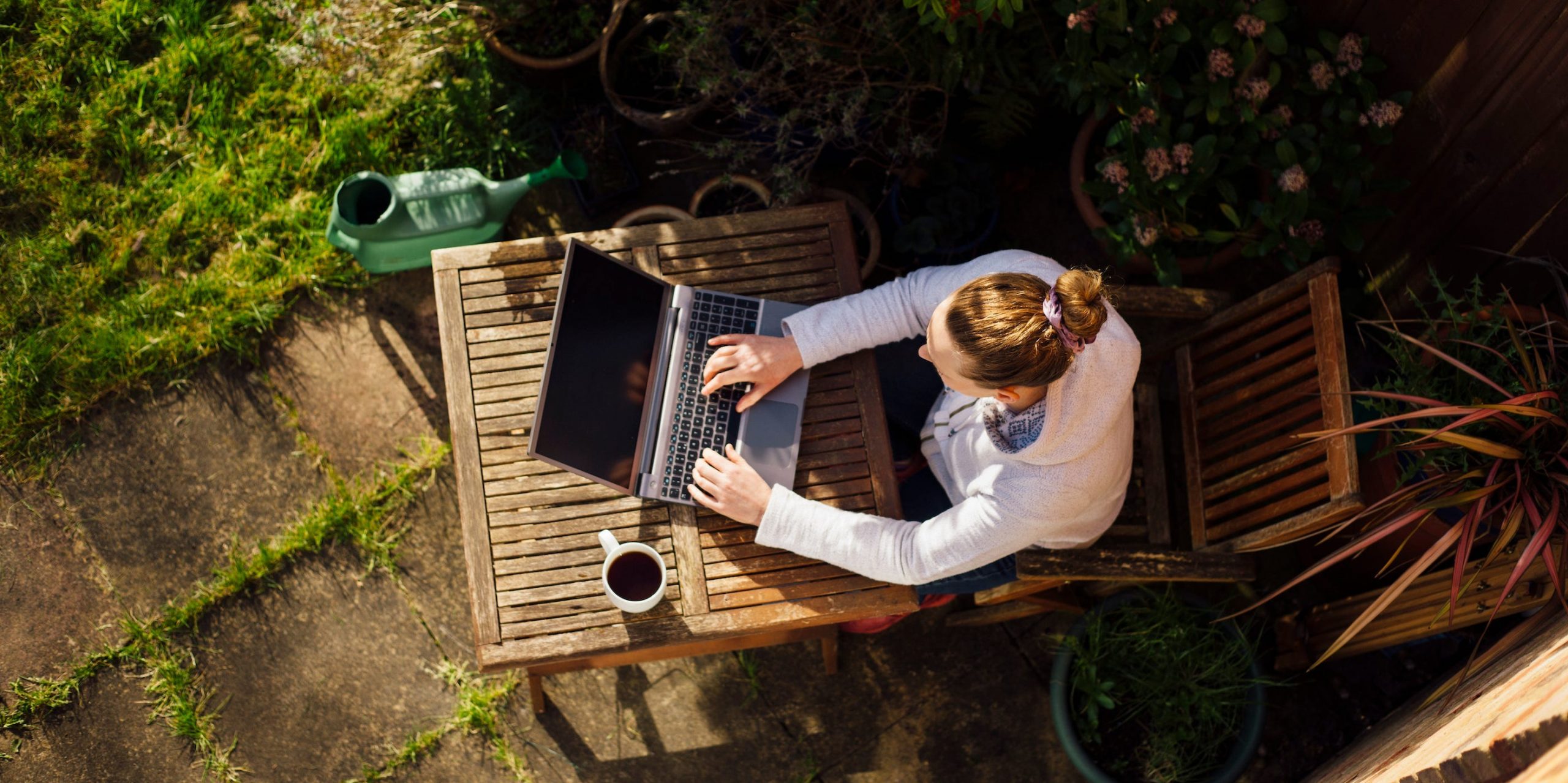 woman working from home using laptop computer garden