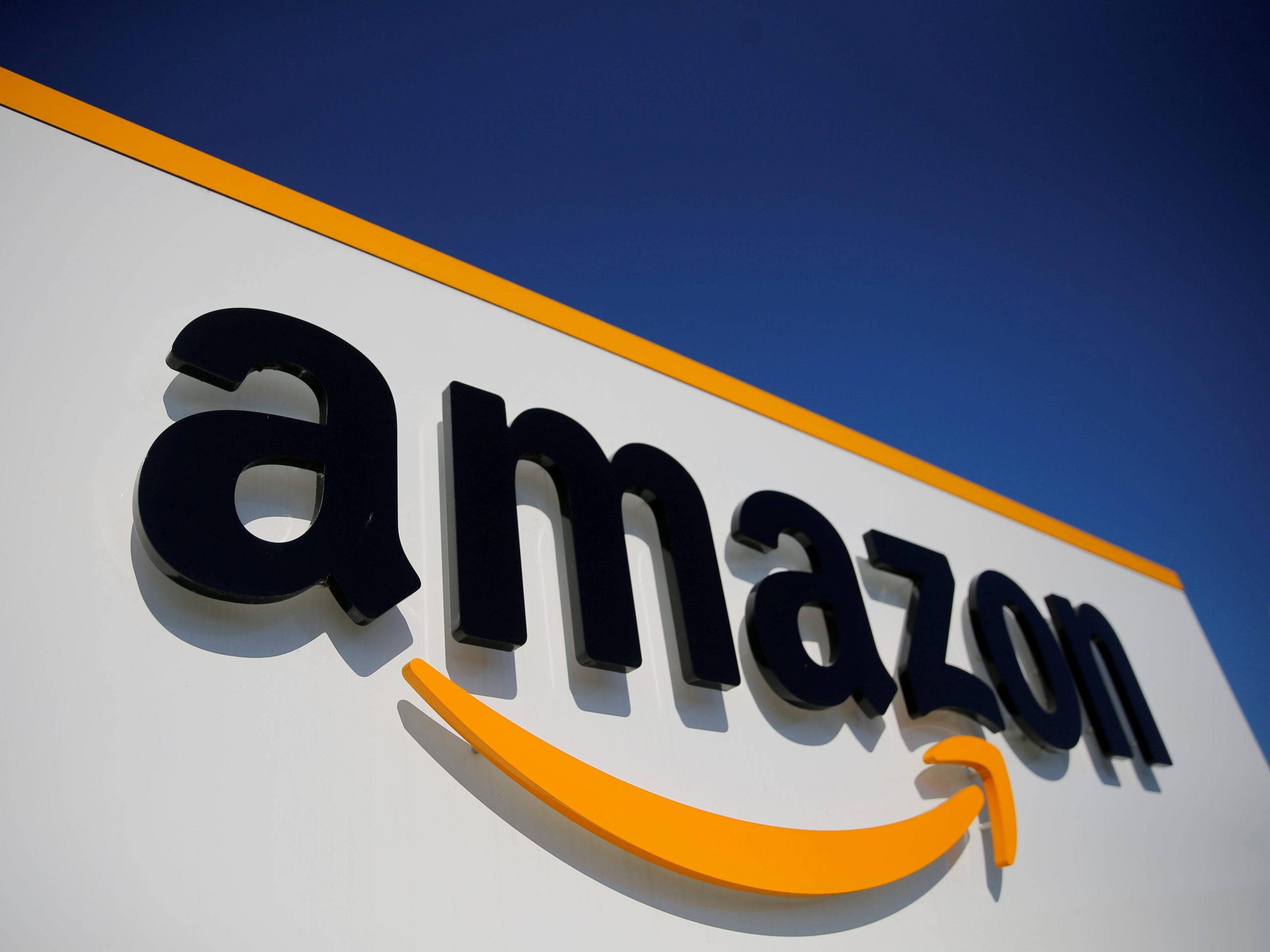 FILE PHOTO: The logo of Amazon is seen at the company logistics center in Lauwin-Planque, northern France, April 22, 2020 after Amazon extended the closure of its French warehouses until April 25 included, following dispute with unions over health protection measures amid the coronavirus disease (COVID-19) outbreak.  REUTERS/Pascal Rossignol 